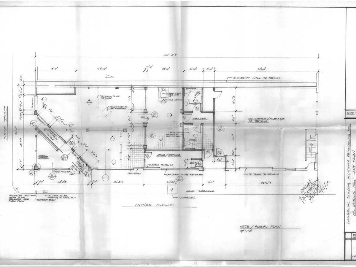 A pencil architectural site and floor plan, creased and unevenly toned across the sheet