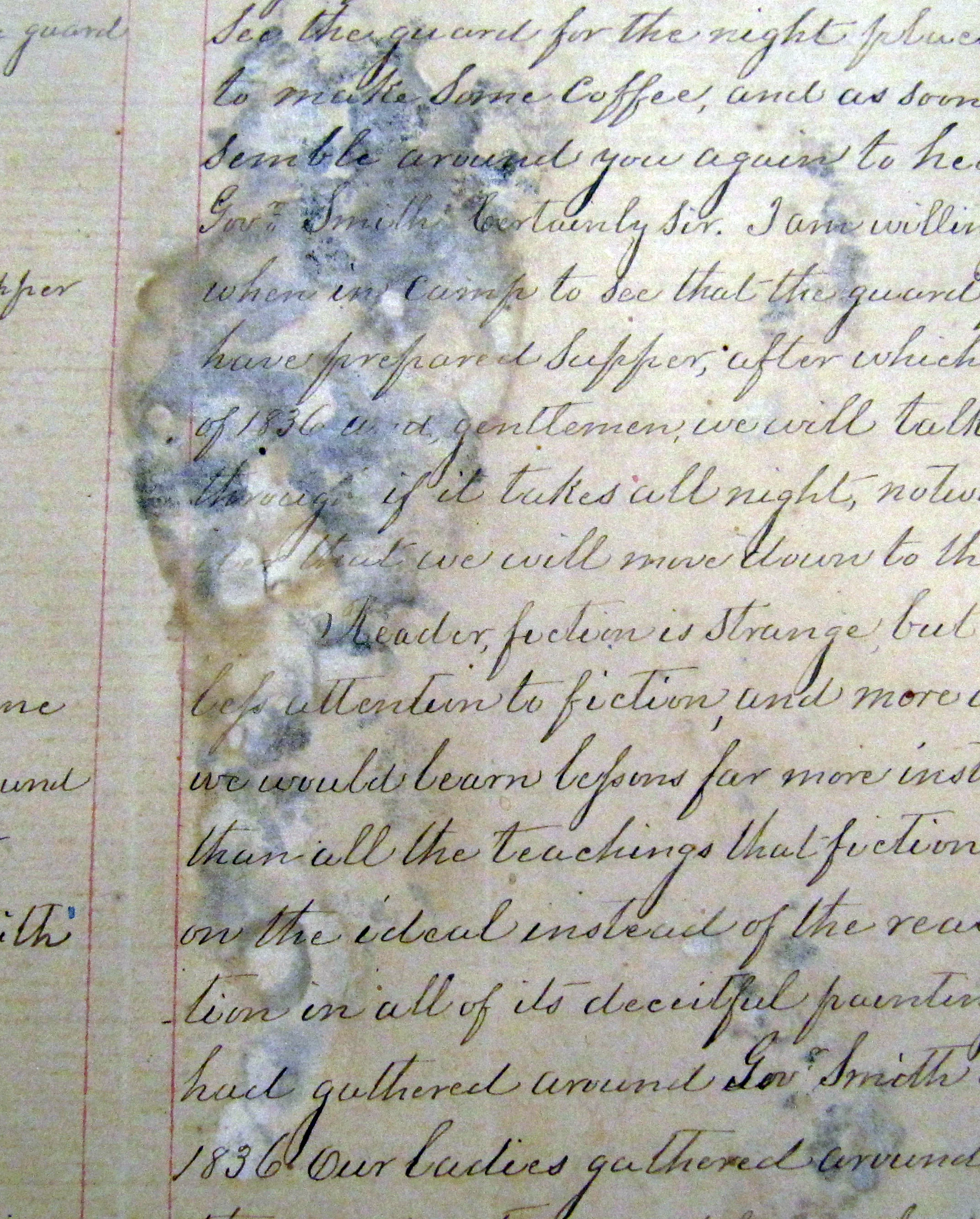 A manuscript page with heavy damp staining and mould bloom spreading across the handwriting